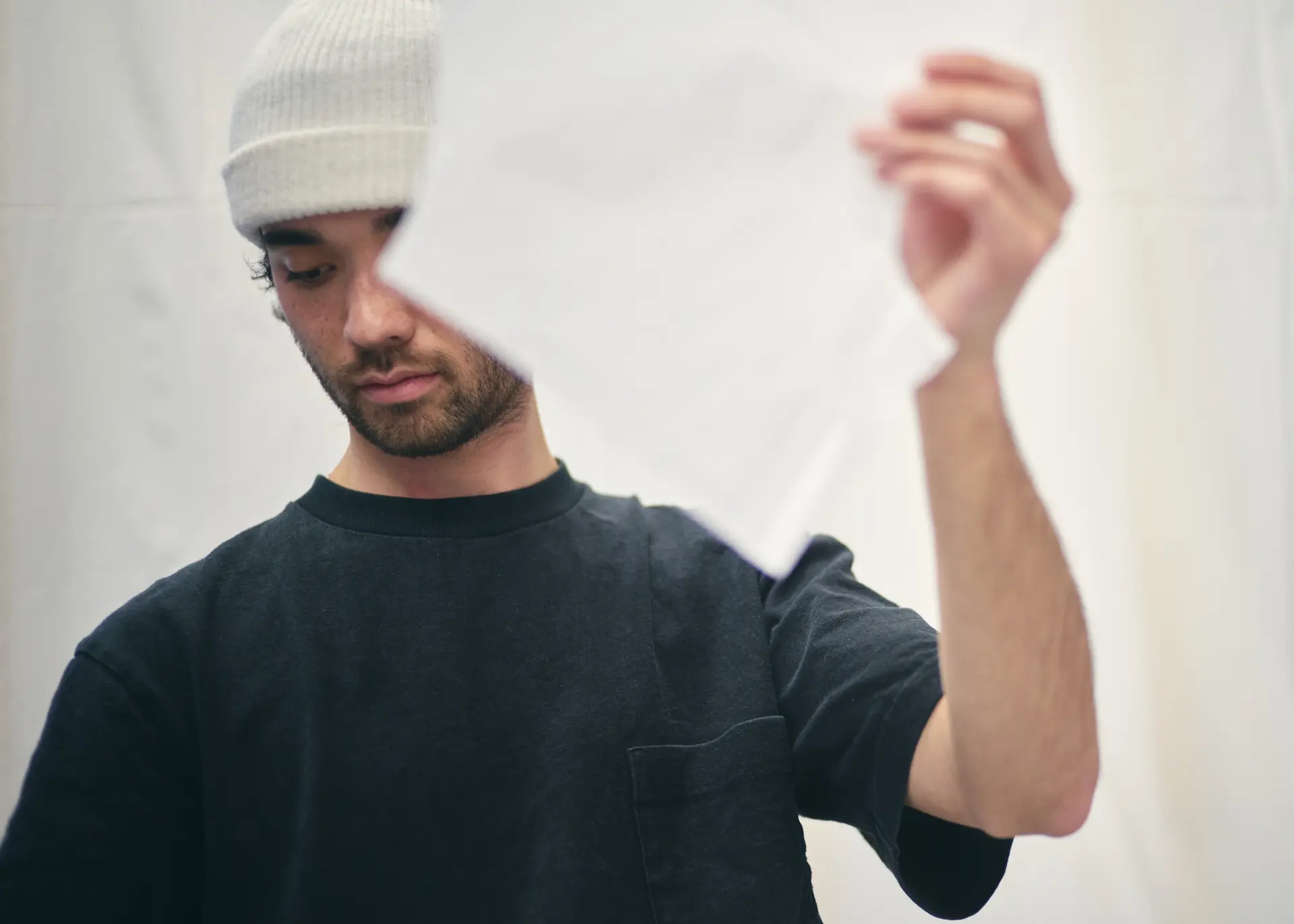 Man holding up a white cloth